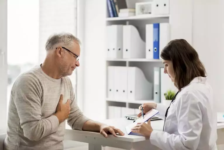 Médica discutindo com paciente que tipos de exames cardiológicos deve fazer